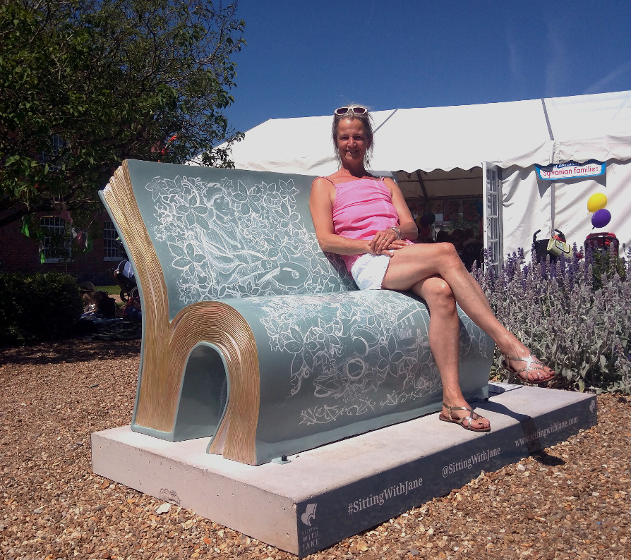 Corinne sitting on the Jane Austen book bench